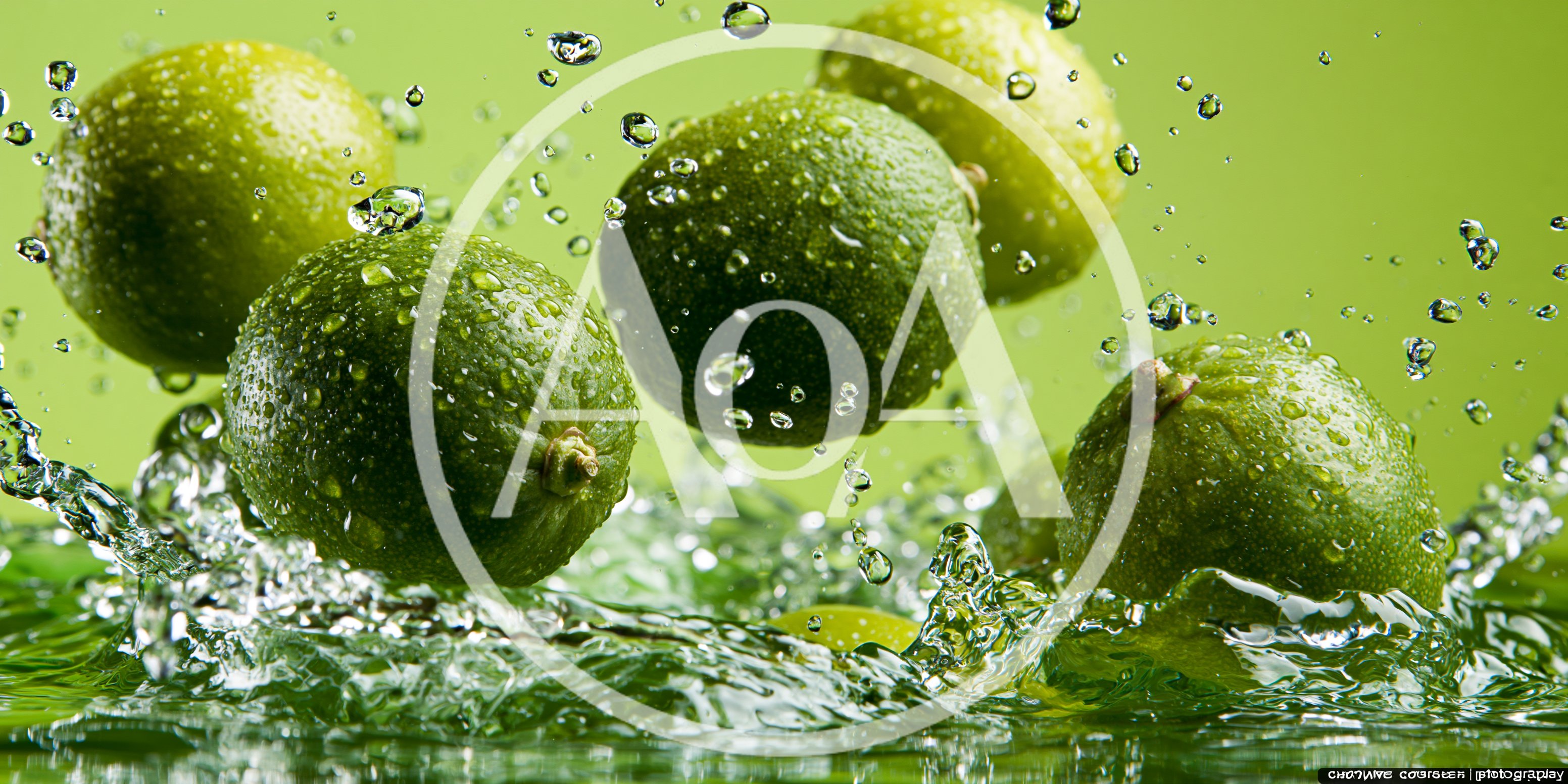 Fresh Green Limes Splashing Into Water