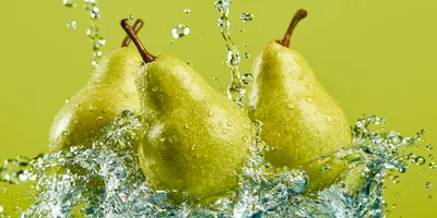 Three Fresh Pears Splashing In Clear Water