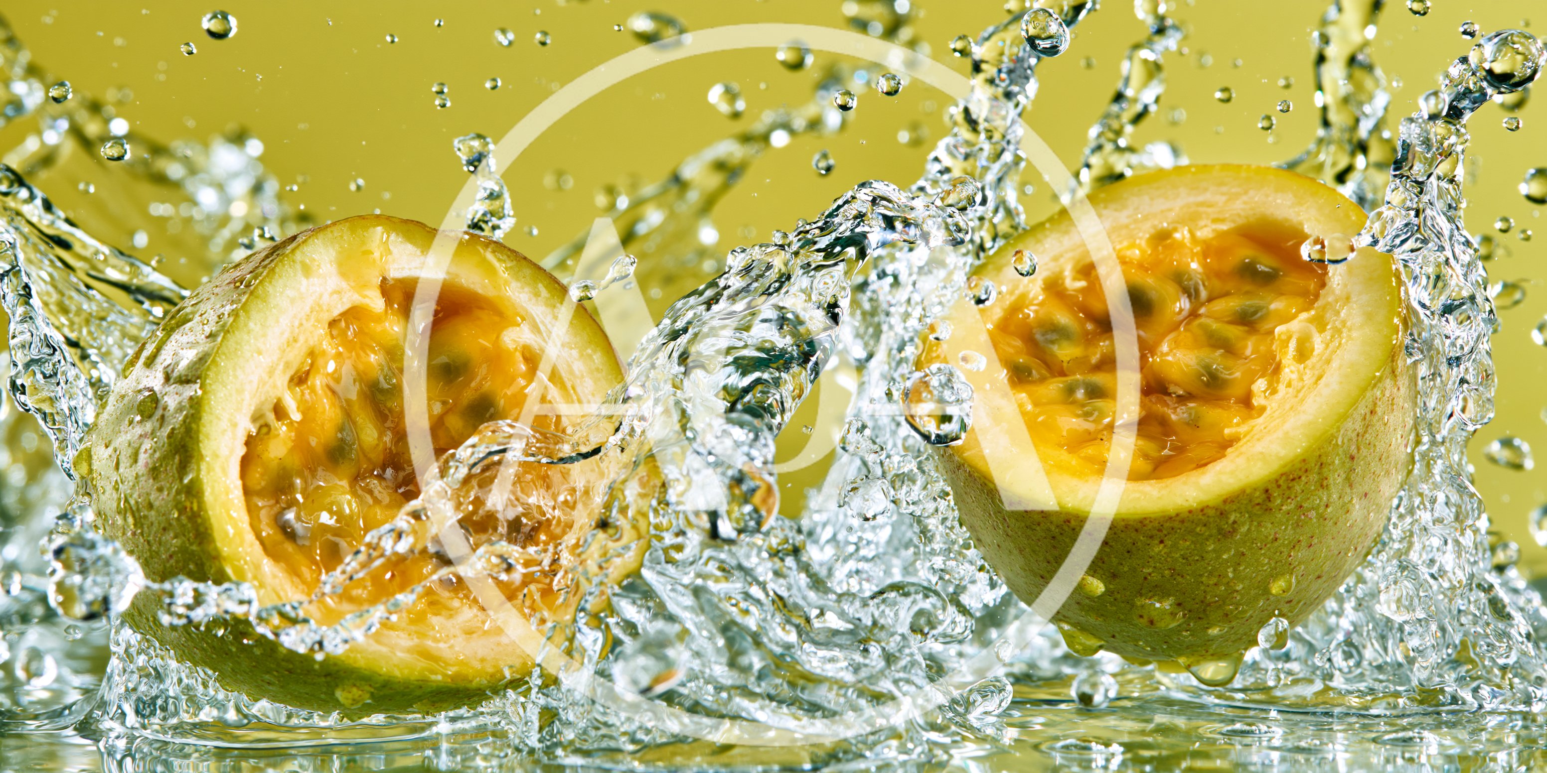 Two Halves Of Passion Fruit Splashing In Water