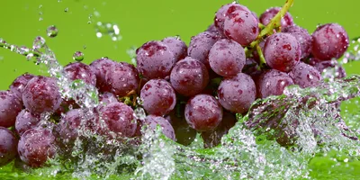 Fresh Red Grapes Splashing In Clear Water