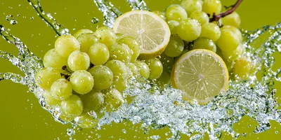 Green Grapes and Lemon Slices Splashing in Water