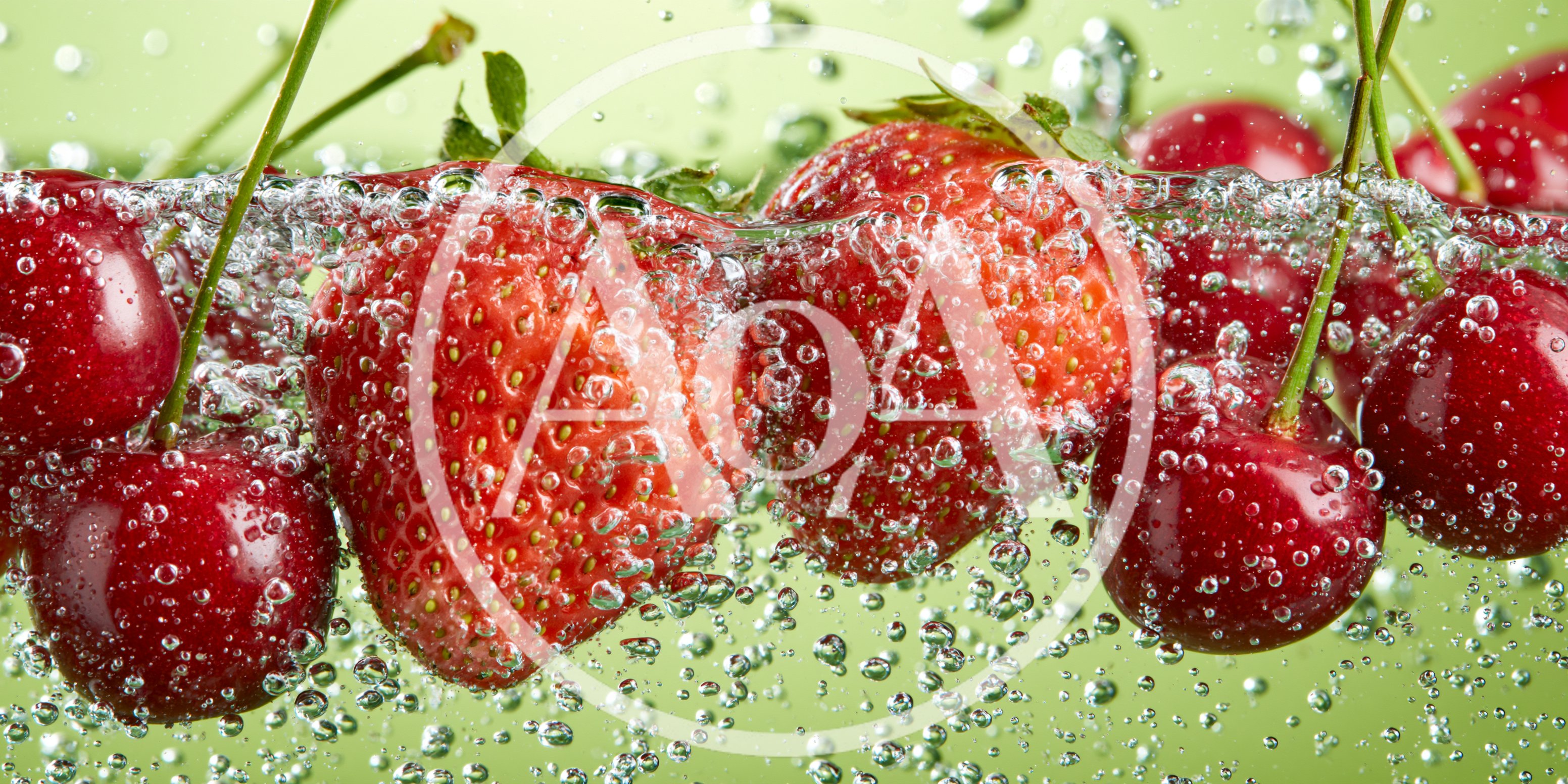 Fresh Strawberries and Cherries Submerged in Sparkling Water