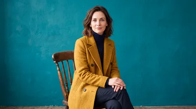 Portrait Of A Professional Woman In A Yellow Coat