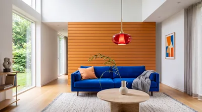 Modern Living Room With Blue Sofa And Orange Wall