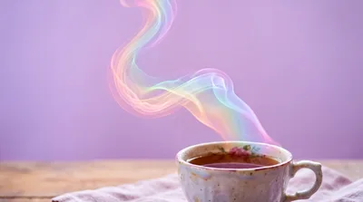Steaming Cup Of Tea With Rainbow Colored Vapor