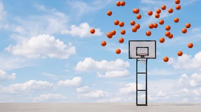 Multiple Basketballs Floating Above Outdoor Basketball Hoop