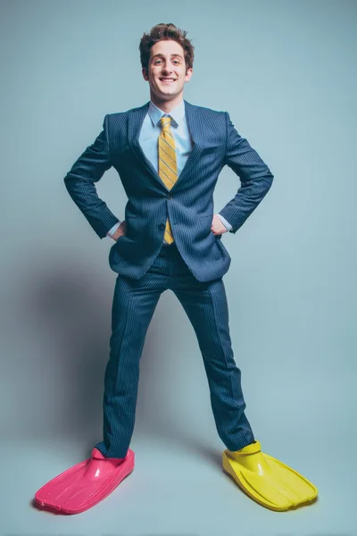 Man In Business Suit Wearing Colorful Swim Fins