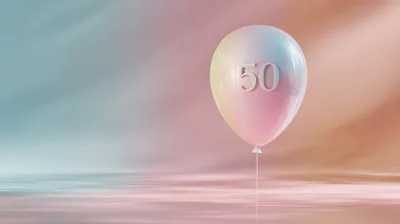 Iridescent Balloon With Number Fifty Floating Above Water