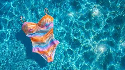 Colorful One Piece Swimsuit Floating In Swimming Pool