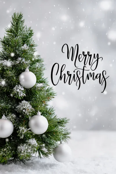 Christmas Tree With White Ornaments And Snow