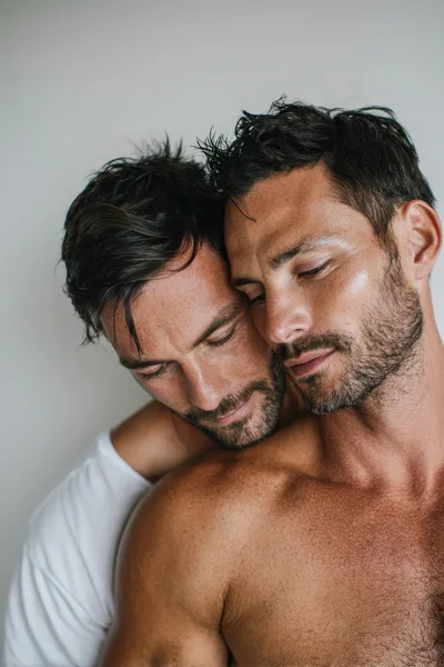 Two Men Embracing With Intimacy And Affection