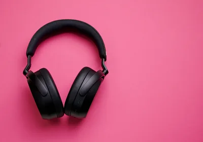 Black Wireless Headphones On A Pink Background