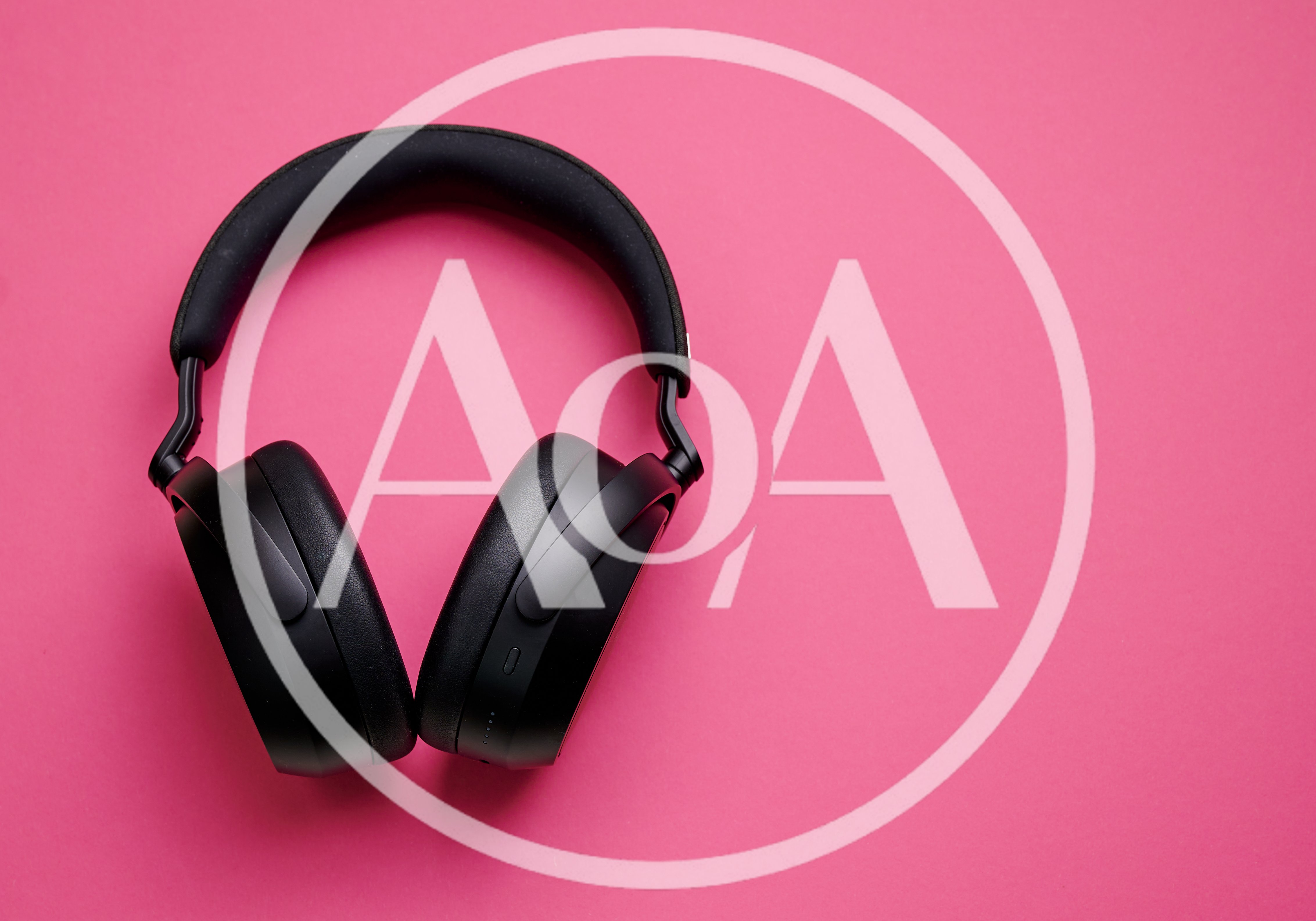 Black Wireless Headphones On A Pink Background