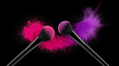 Makeup Brushes With Pink And Purple Powder Explosions