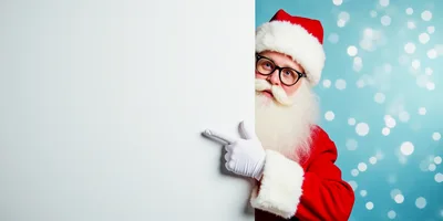 Santa Claus Pointing At A Blank White Board