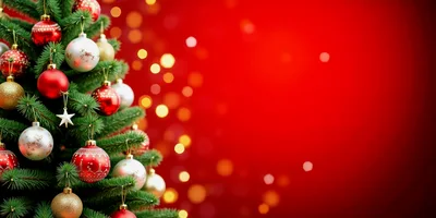 Christmas Tree Decorated With Ornaments Against Red Background