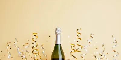 Champagne Bottle With Gold And Silver Party Streamers