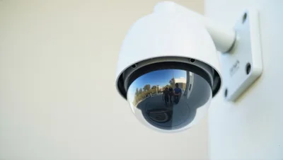 Security Dome Camera Mounted On A White Wall