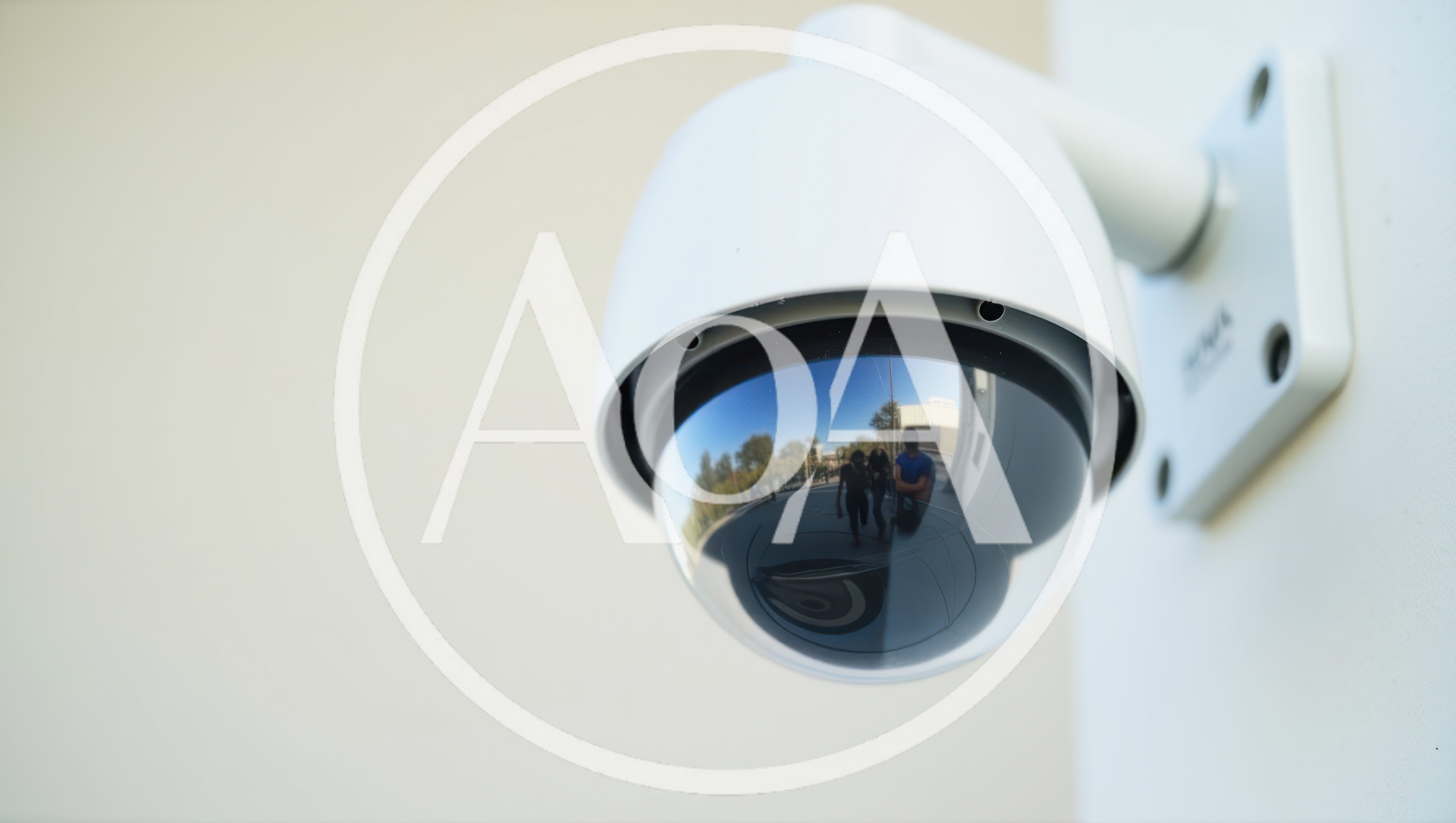 Security Dome Camera Mounted On A White Wall