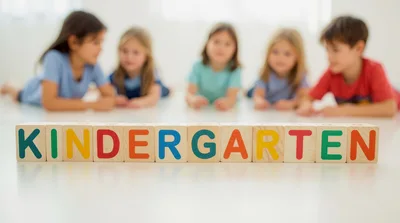 Children Lying On Floor With Kindergarten Wooden Blocks