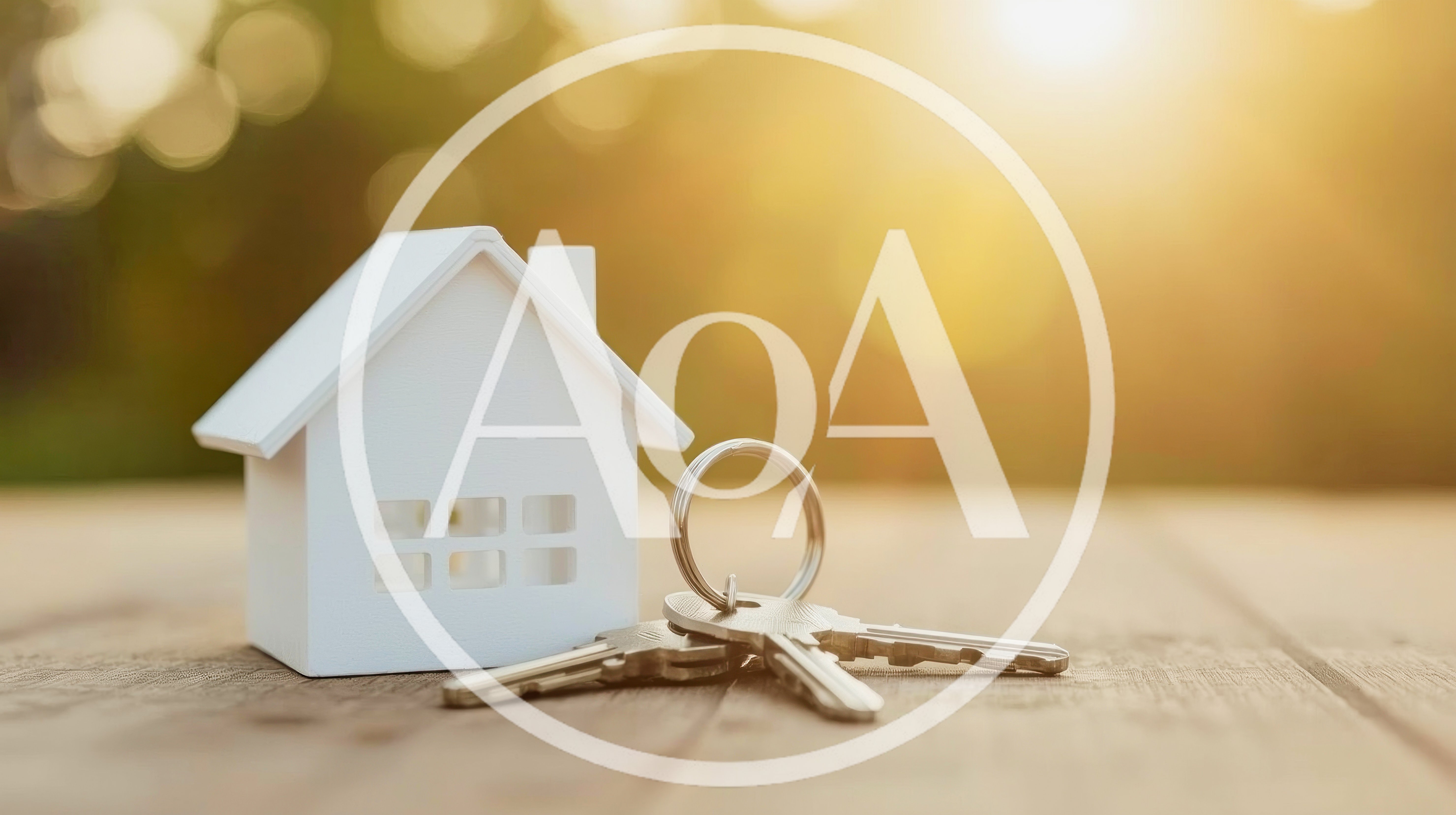 Miniature House Model With Metal Keys On Wooden Table