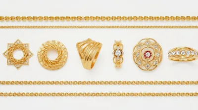 Collection Of Gold Jewelry And Chains On White Background