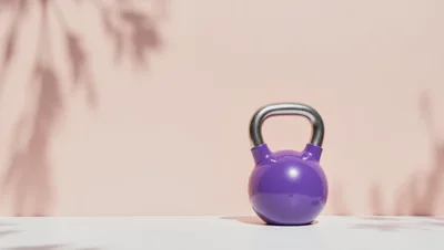 Purple Kettlebell on White Surface with Soft Shadows