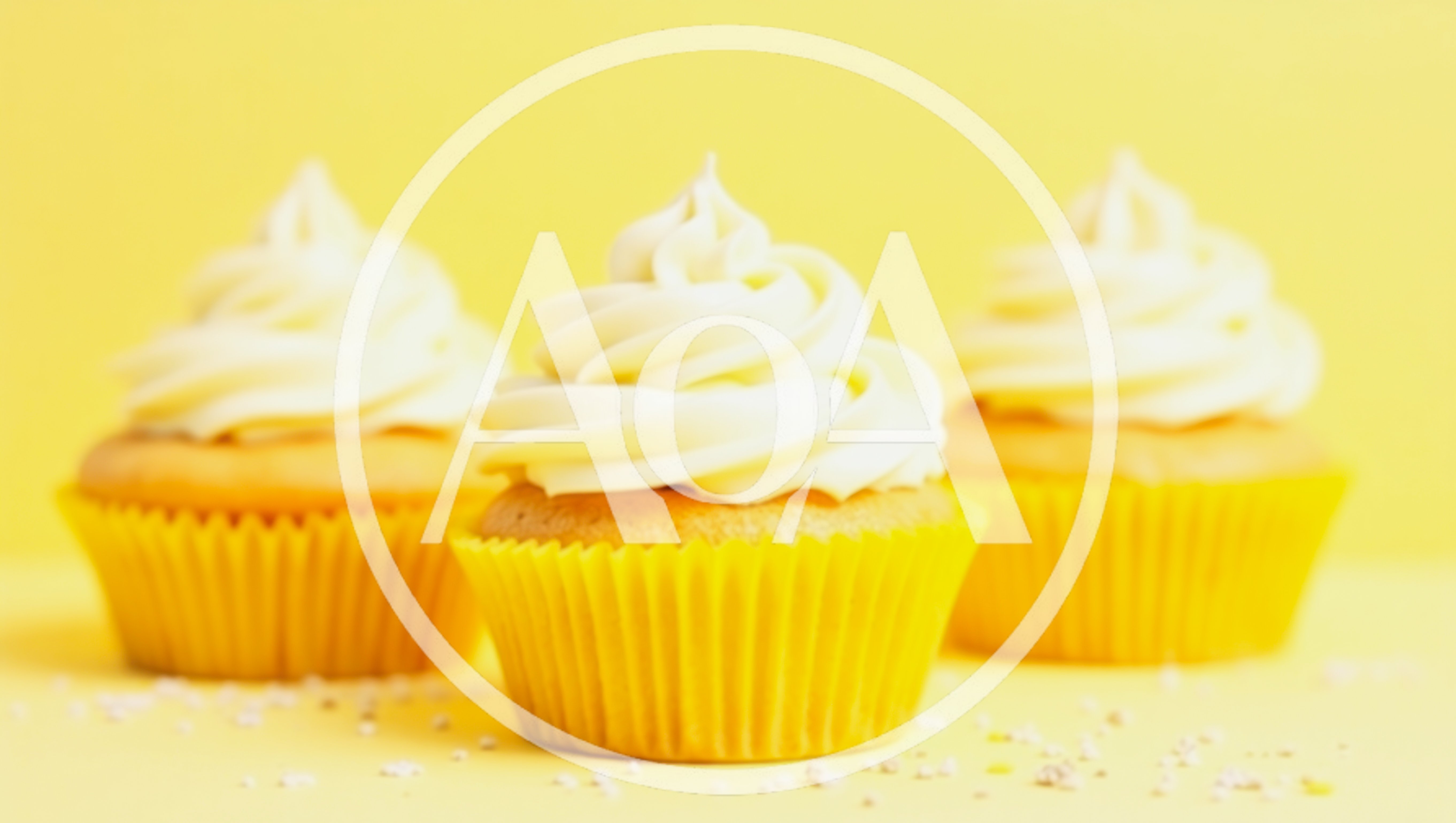 Three Vanilla Cupcakes With White Frosting On Yellow Background