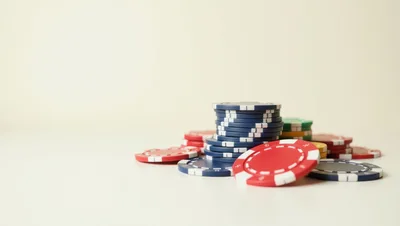 Stack Of Colorful Casino Poker Chips On White Surface