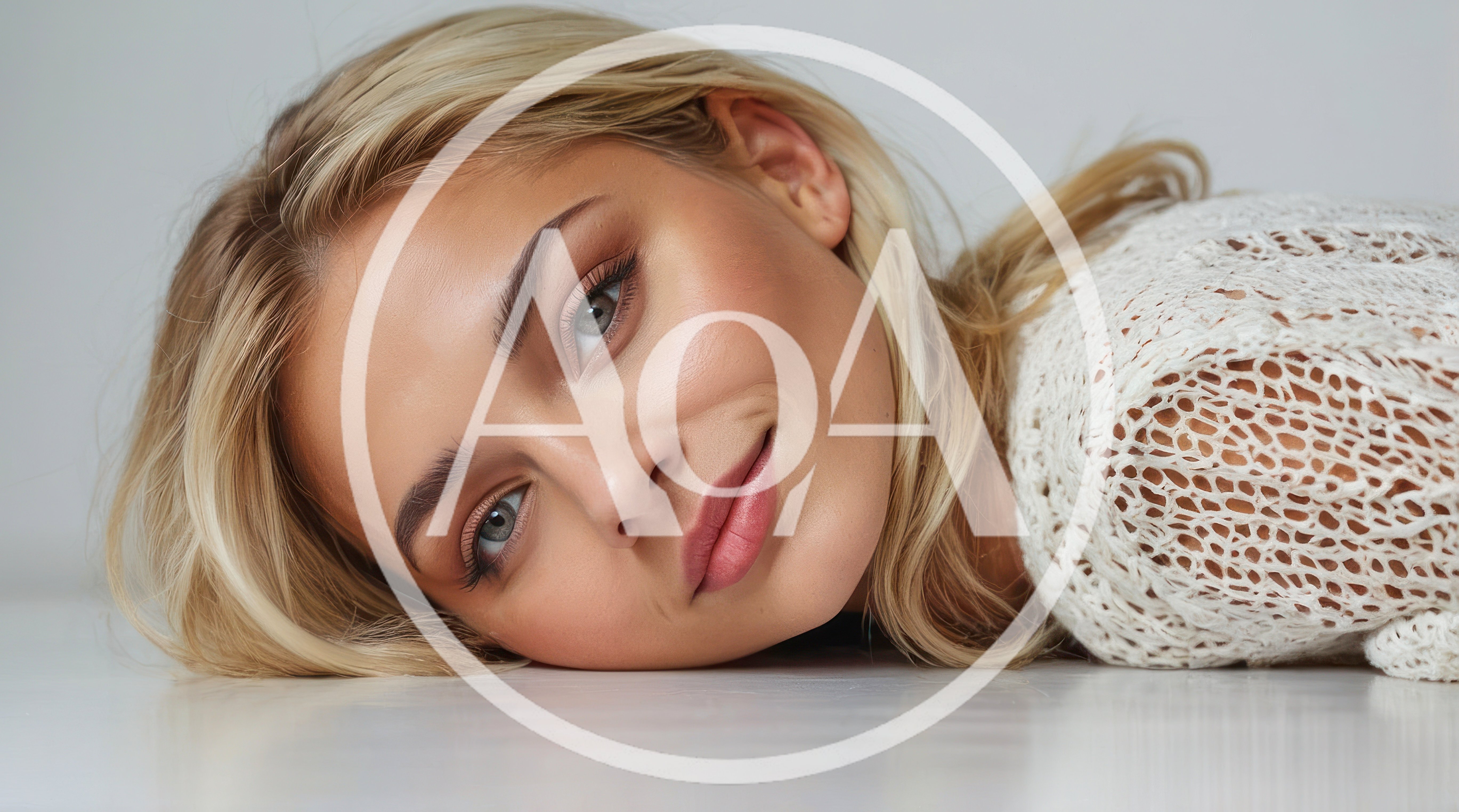 Blonde Woman Lying Down Looking At Camera