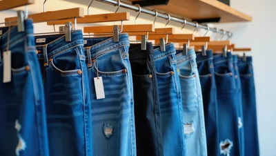 Row Of Denim Jeans Hanging On A Clothing Rack