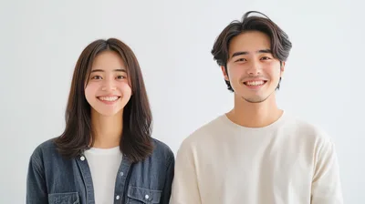 Young Asian Couple Smiling Together Against White Background