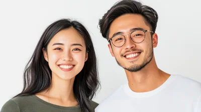 Young Asian Couple Smiling Together Against White Background