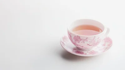 Floral Teacup With Tea On White Background