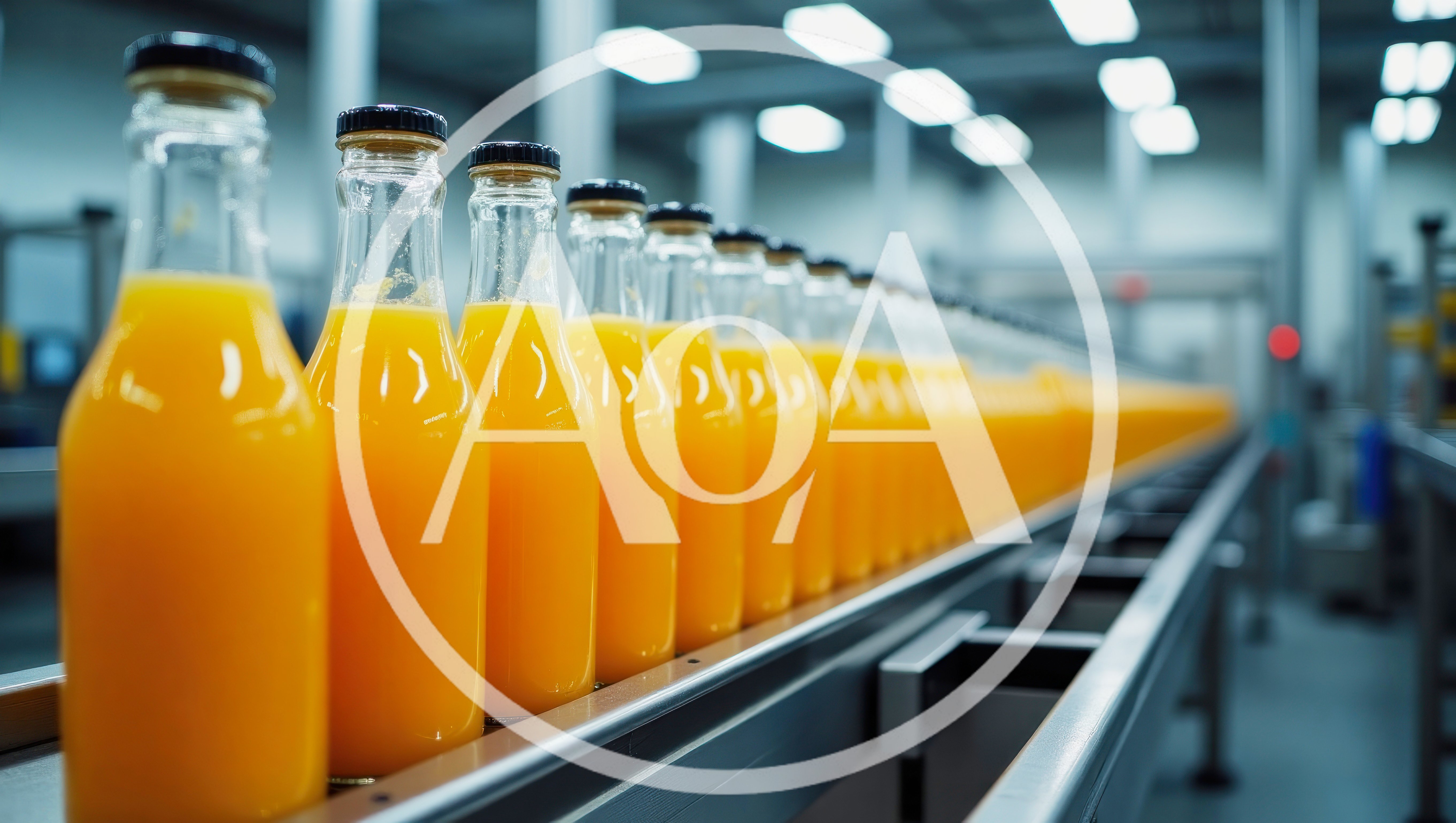 Orange Juice Bottles Moving Along Industrial Conveyor Belt