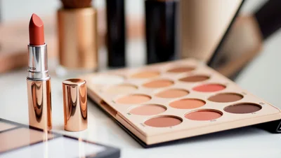Makeup Palette and Lipstick on a Vanity Table
