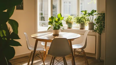 Modern Dining Room With Round Table And Potted Plants