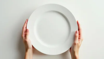 Woman Holding An Empty White Plate