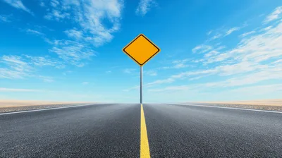 Blank Yellow Road Sign On Empty Asphalt Highway