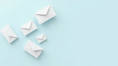 White Envelopes Floating on Light Blue Background
