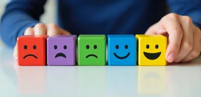 Person Choosing Positive Feedback With Colorful Emotion Blocks