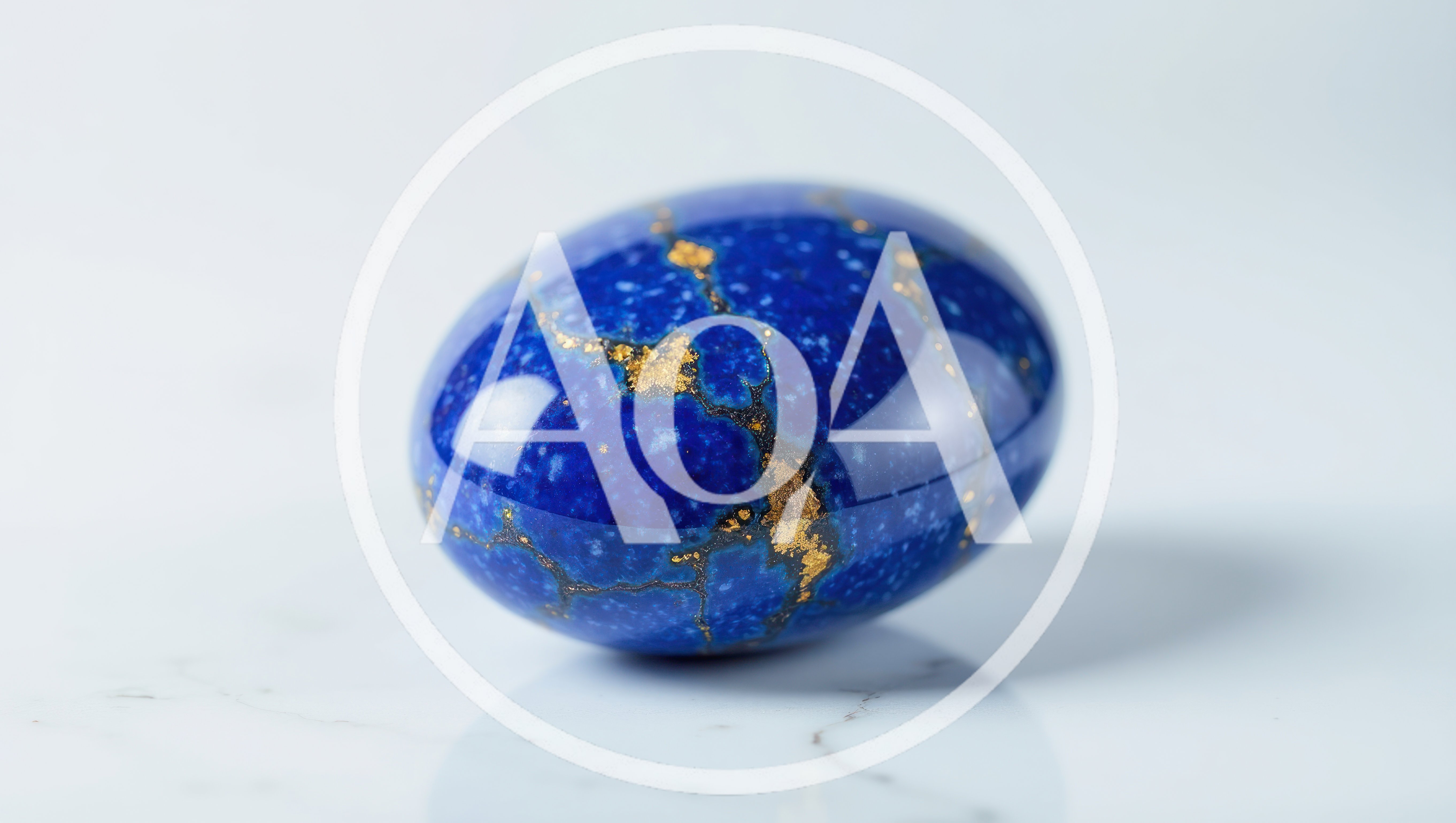 Polished Lapis Lazuli Egg on White Marble Surface