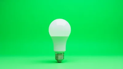White LED Light Bulb On Green Background