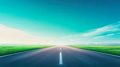 Empty Asphalt Road Through A Green Meadow