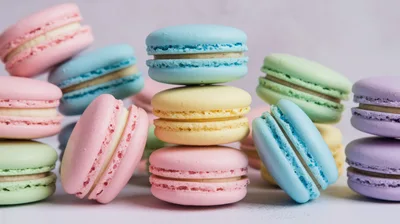 Assorted Colorful French Macarons Stacked On A Surface