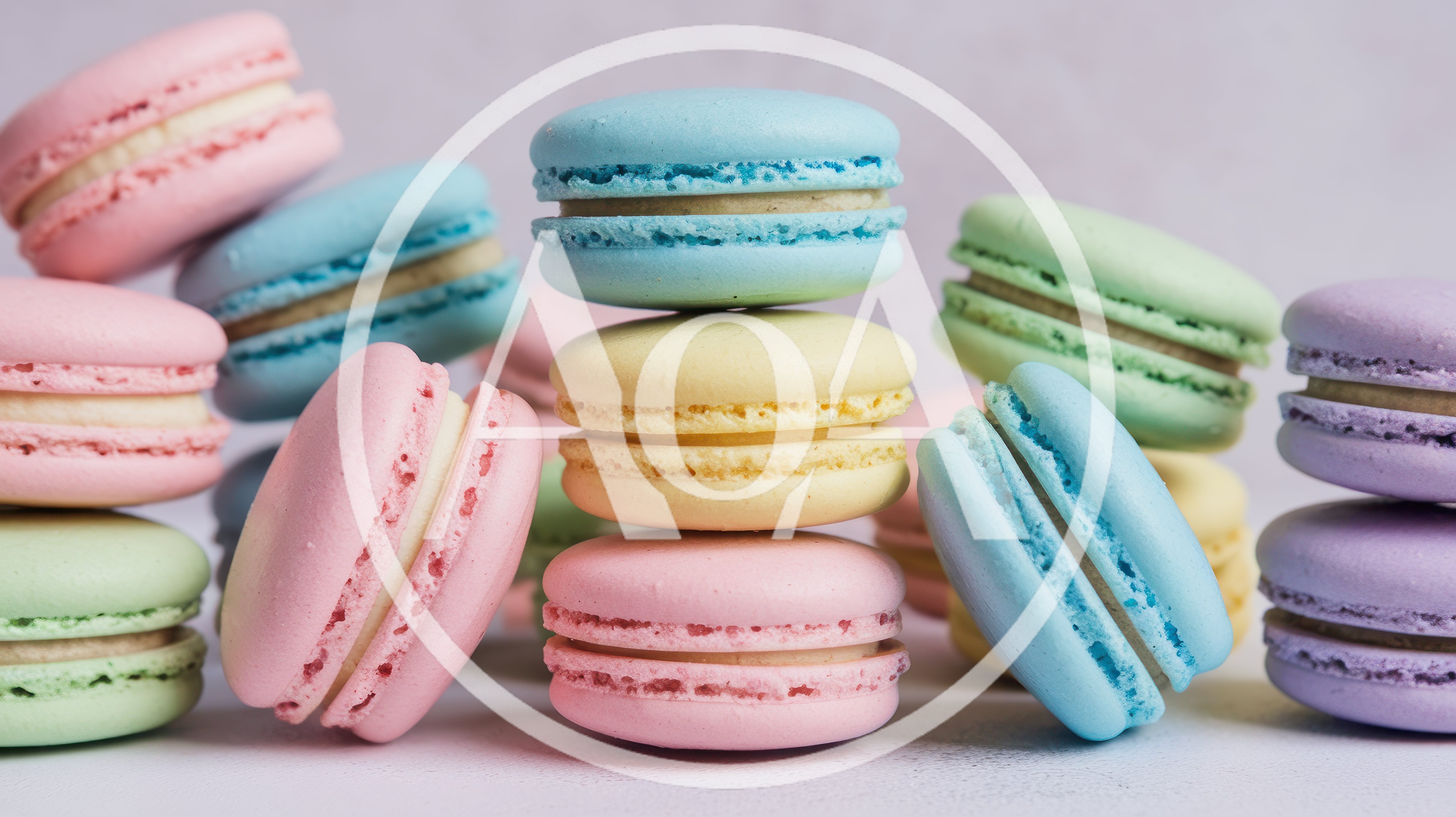 Assorted Colorful French Macarons Stacked On A Surface