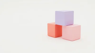Three Pastel Colored Cubes Stacked On White Background