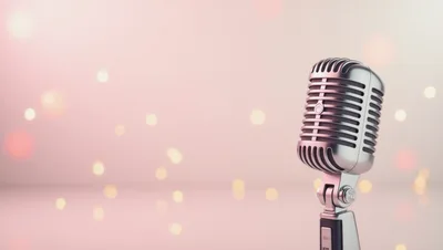Vintage Silver Microphone Against Soft Pink Bokeh Background