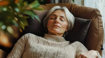Mature Woman Resting With Eyes Closed In Armchair