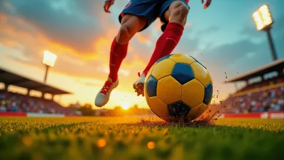 Soccer Player Kicking Ball On Stadium Field At Sunset